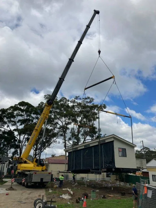 Cabin lifted into a backyard